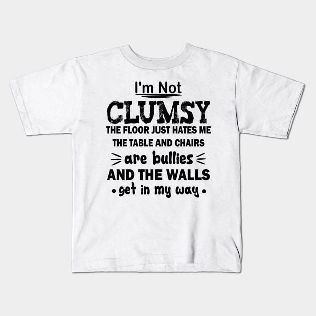 i'm not clumsy the floor just hates me the table and chairs are bullies and the walls get in my way Kids T-Shirt by mdr design